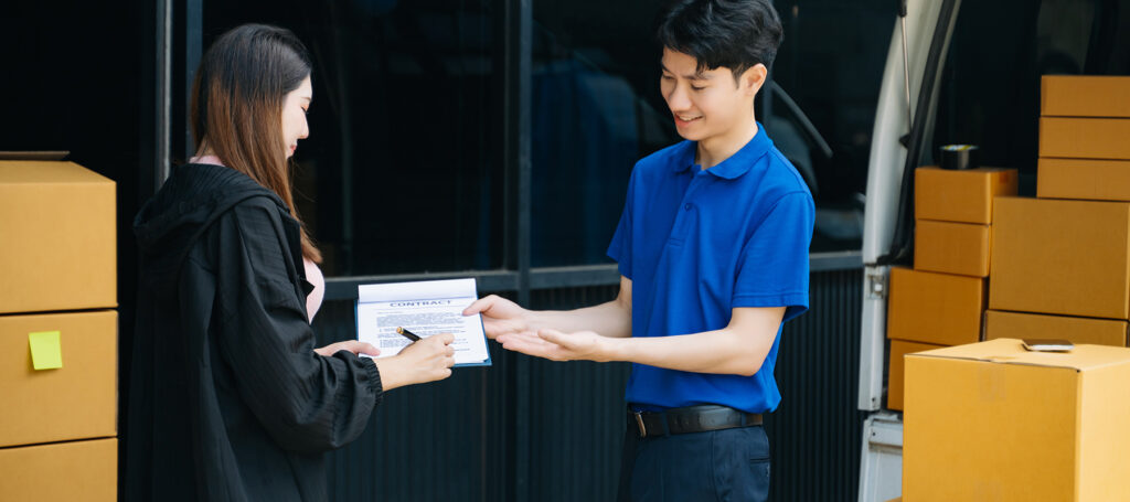 Courier handing over urgent packages to business client
